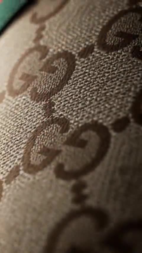 Frame from a product video: a patterned sneaker under a spotlight